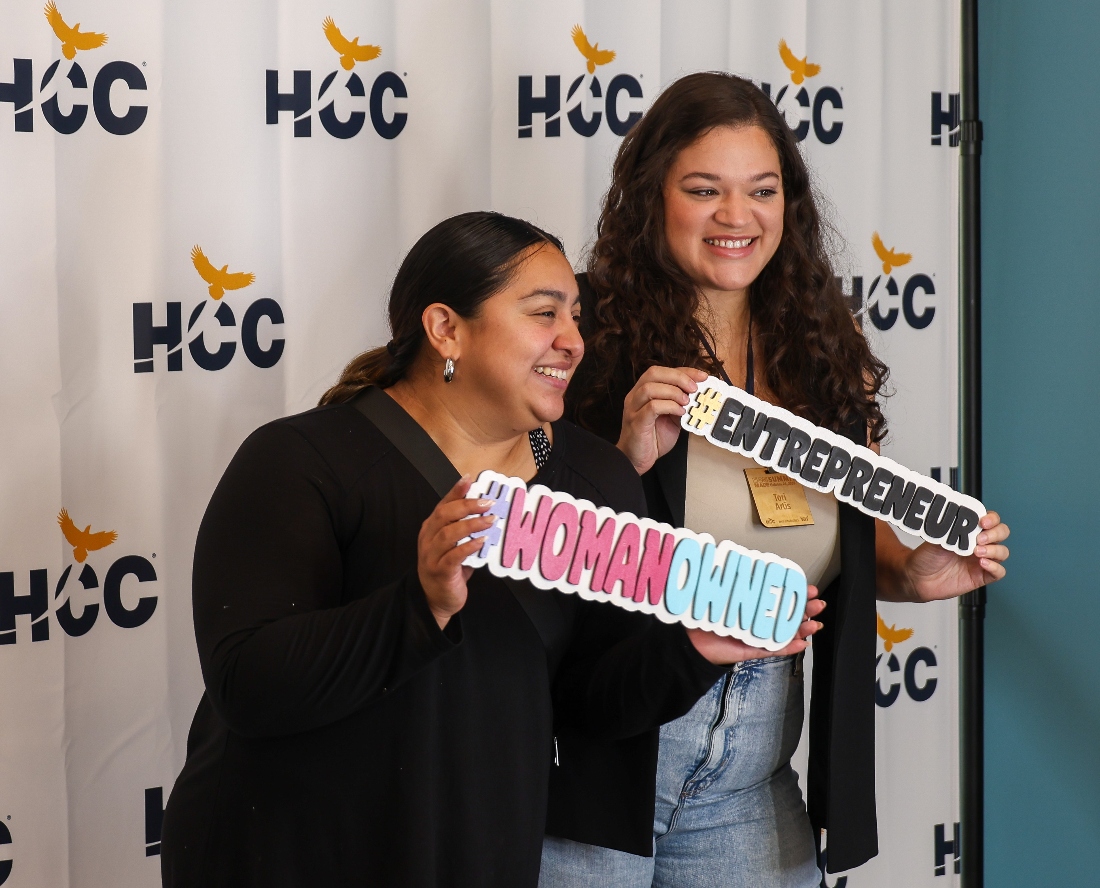 Small Business owners at annual HOUMade Summit holdings signs #WomanOwned and #Entrepreneur.