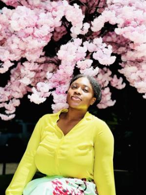 student in bright colored shirt with pink flowers