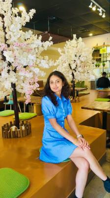Women posing in a restaurant with a floral background