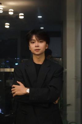 Male student formally dress in a black suit